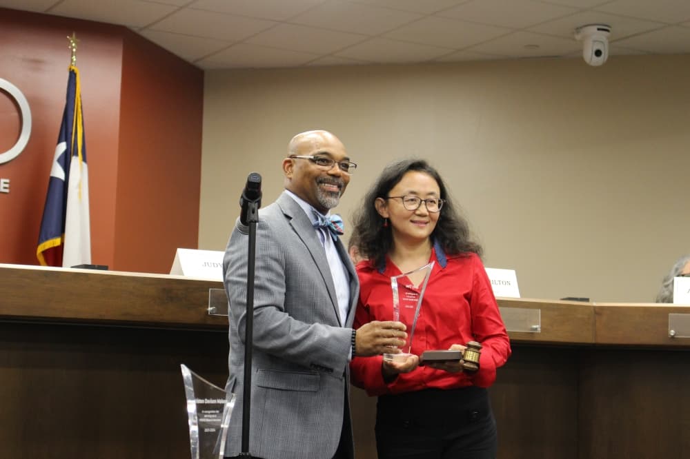 Outgoing trustee Judy Dae stands next to Superintendent Marc Smith on May 13. (Kelly Schafler/Community Impact)