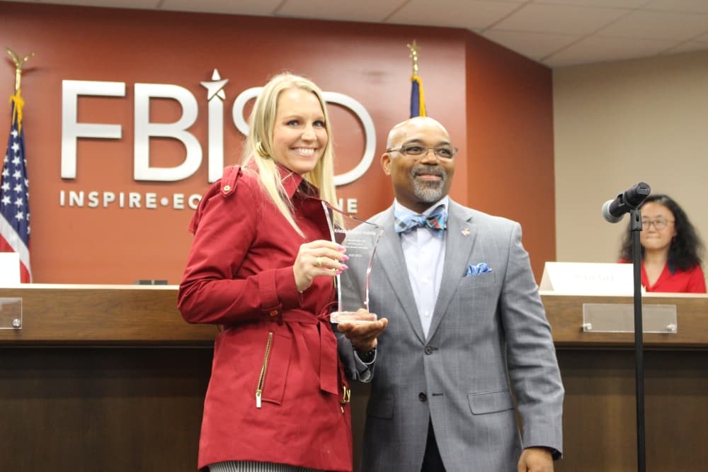 Outgoing trustee Kristen Davison Malone stands next to Superintendent Marc Smith on May 13. (Kelly Schafler/Community Impact)