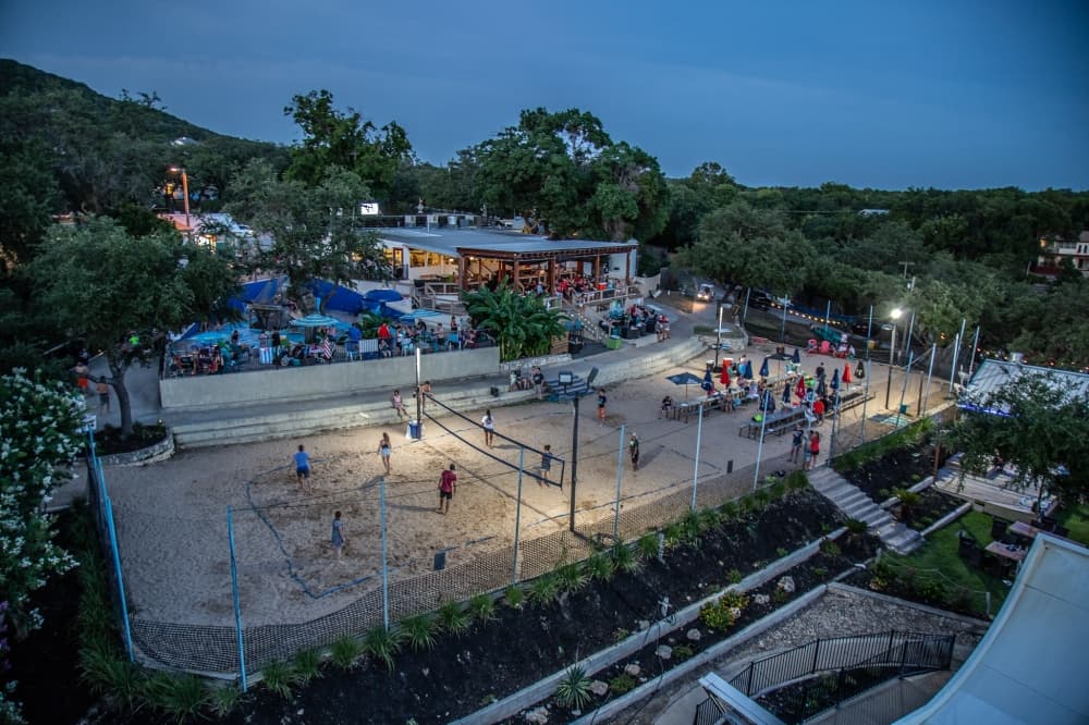 sand volleyball court with people during the evening 