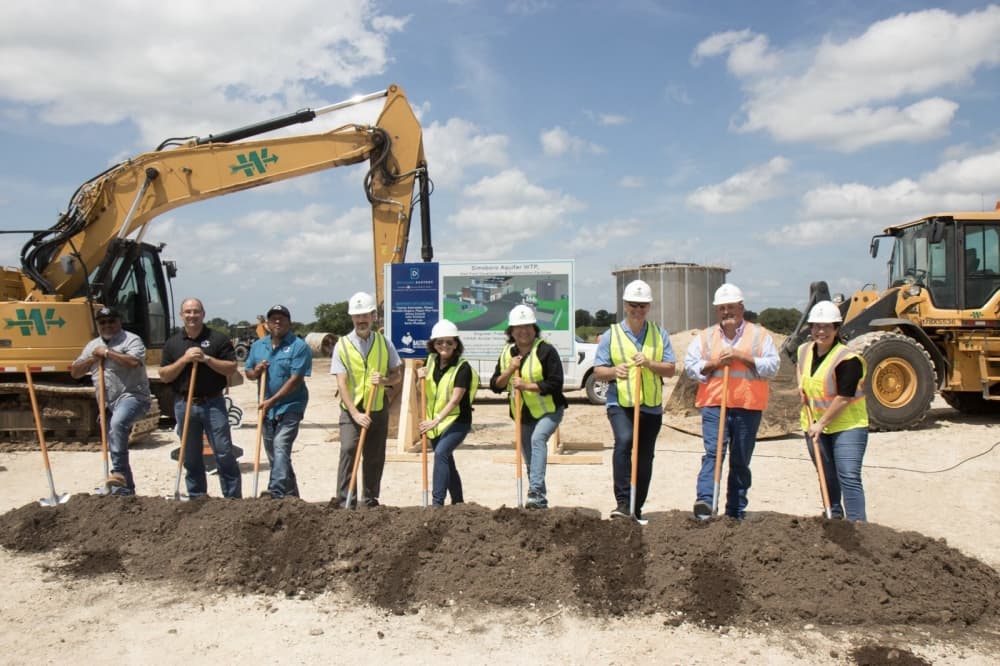 A group of adults at a groundbreaking ceremony.