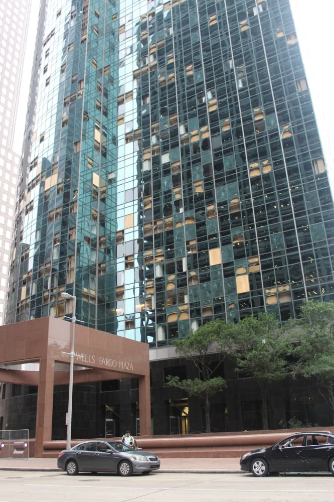 Dozens of windows were blown out by strong winds at the Wells Fargo Plaza building. (Shawn Arrajj/Community Impact)