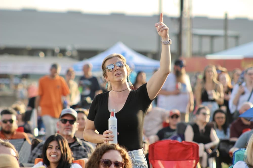 A woman in an audience sings
