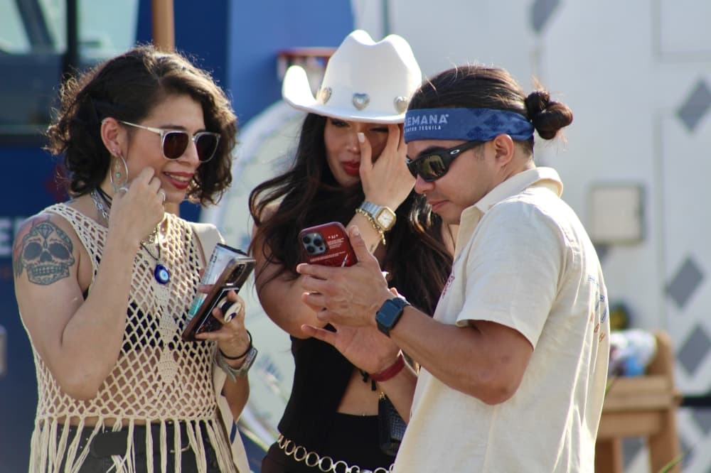 People look at their phones outdoors