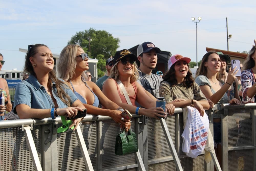 People watch an outdoor music performance
