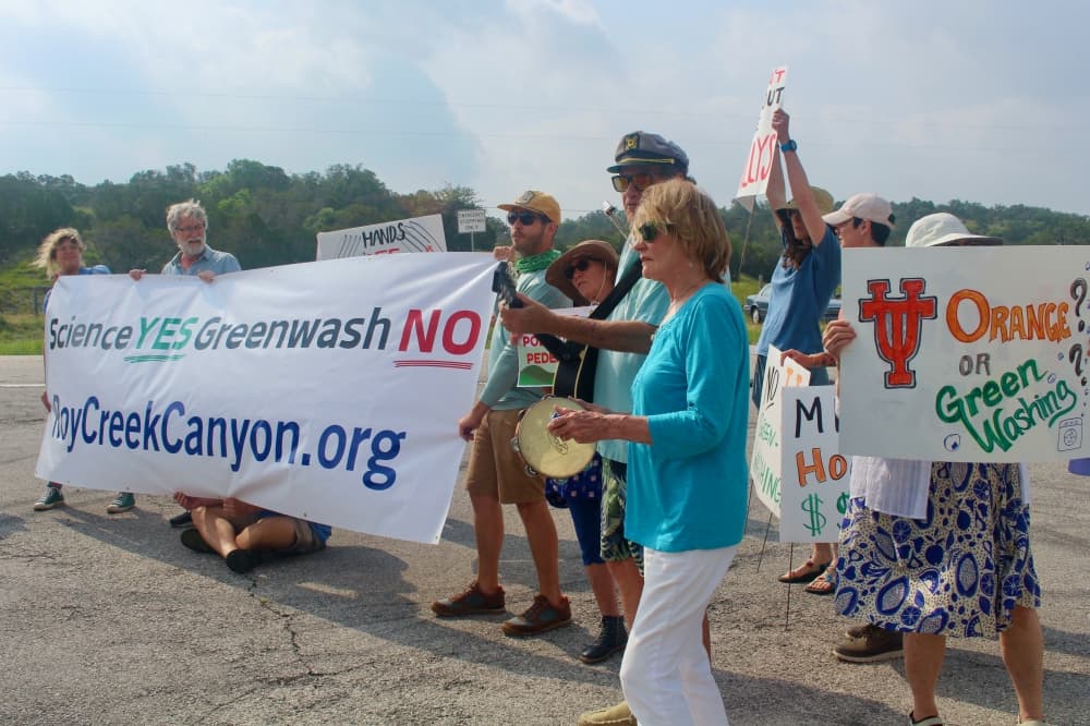 Protestors outside the event said they hoped to make UT-affiliated attendees aware of their opposition to the Mirasol Springs plans. (Kameryn Griesser/Community Impact)