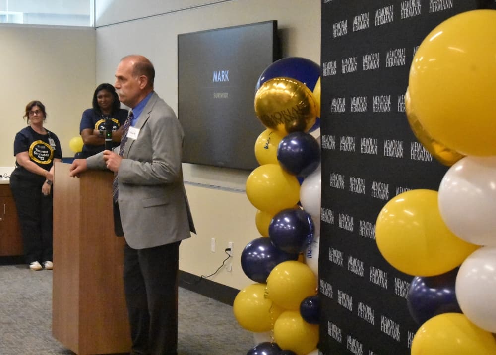 A man speaks at a podium