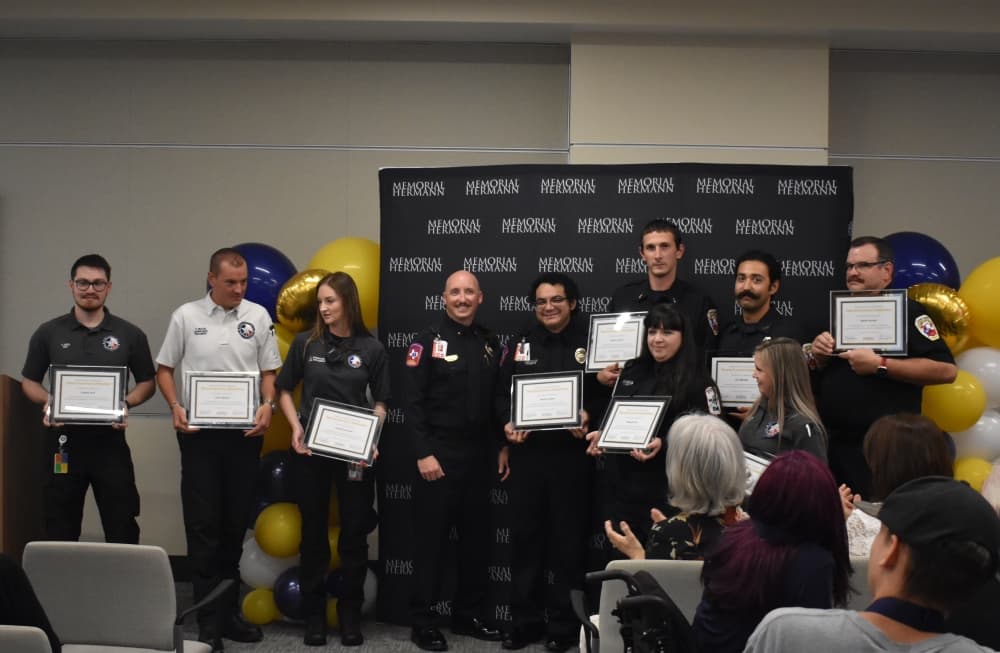 Emergency responders line up with certificates