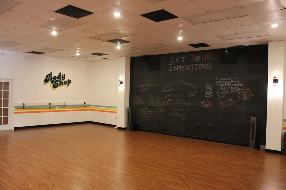 A chalkboard wall in the Body Shop studio is filled with answers to monthly questions for class attendees to share their thoughts. (Sarah Hernandez/Community Impact)
