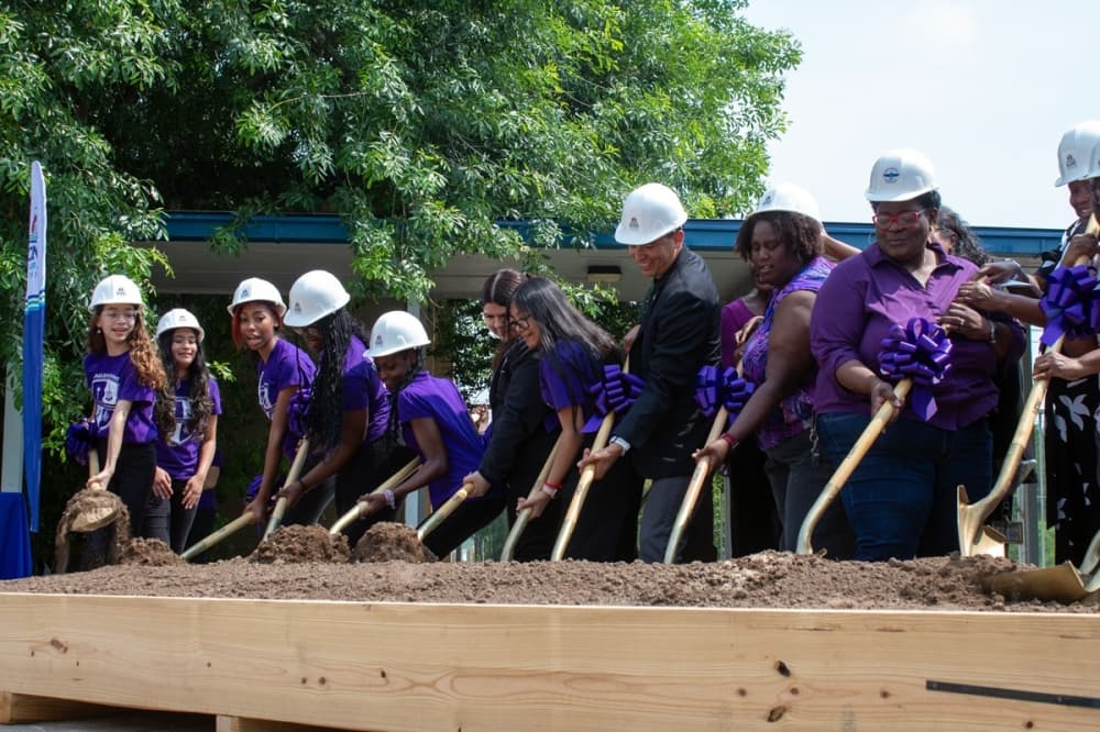 (From left to right) Sadler Means Young Women's Leadership Academy students, Austin ISD Superintendent Matias Segura, Sadler Means Principal De'Sean Roby and AISD board member Candace Hunter at the groundbreaking ceremony for Sadler Mean's modernization project May 21. (Elle Bent/Community Impact)