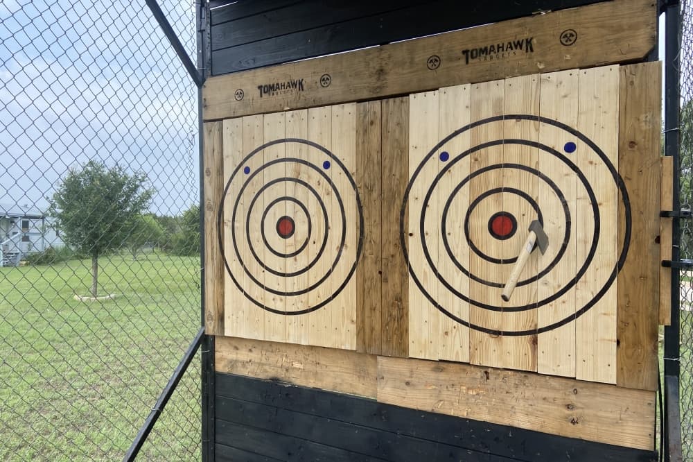 A close up of two targets with an axe in the center