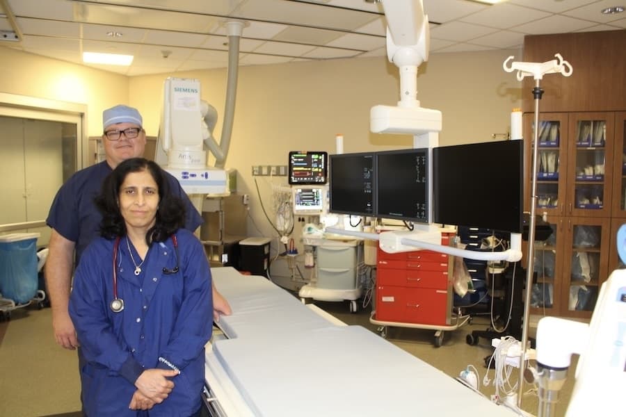 Picture of two people in a hospital lab room.