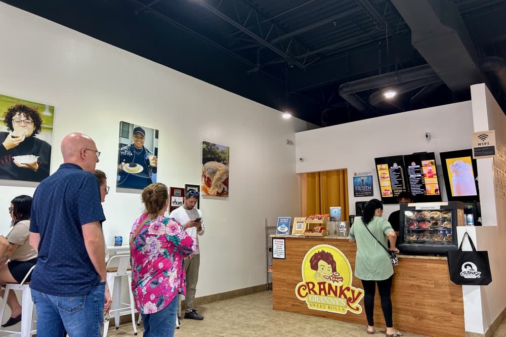 Customers wait to purchase and pick up cinnamon rolls inside Cranky Granny's. (Brooke Sjoberg/Community Impact)