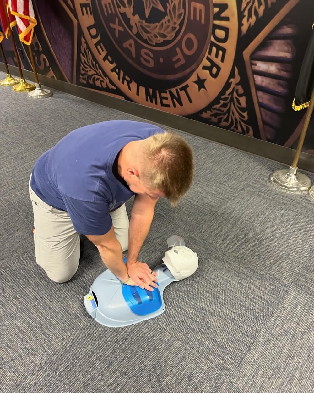 Man practices CPR technique on mannequin
