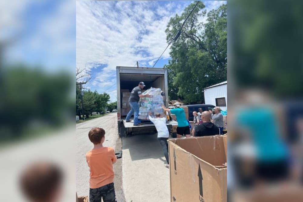 volunteers pack up a box truck with boxes