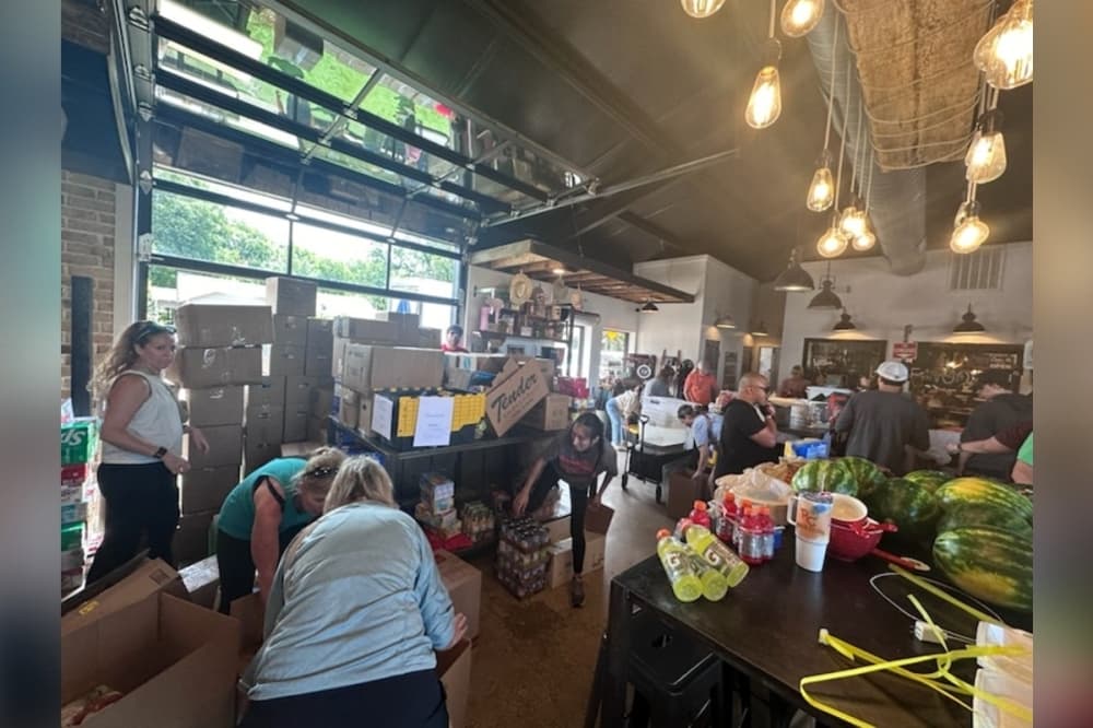 volunteers packing up boxes of donations inside little wooden penguin in celina