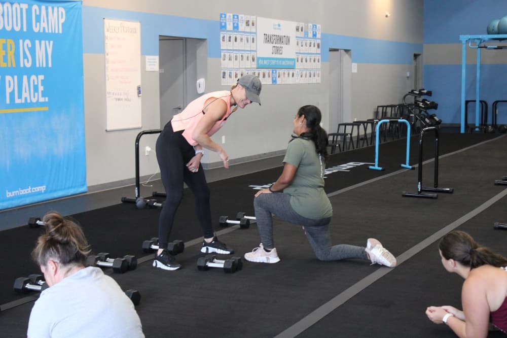 A trainer working with a member