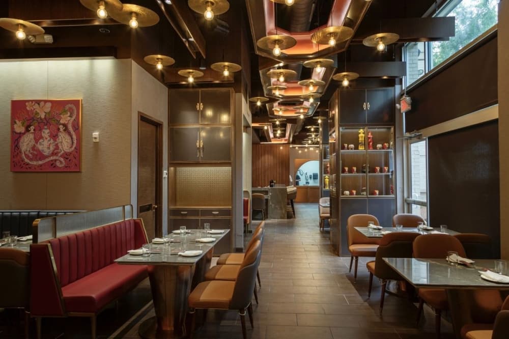 a restaurant interior with tables, booths and light fixtures
