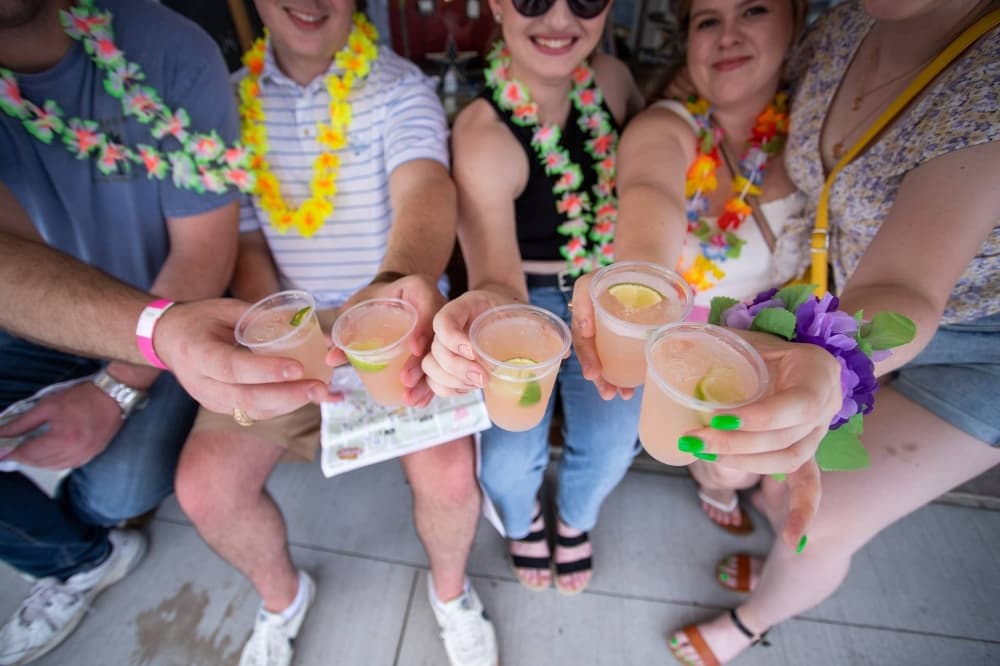 Several people toasting with margaritas. 