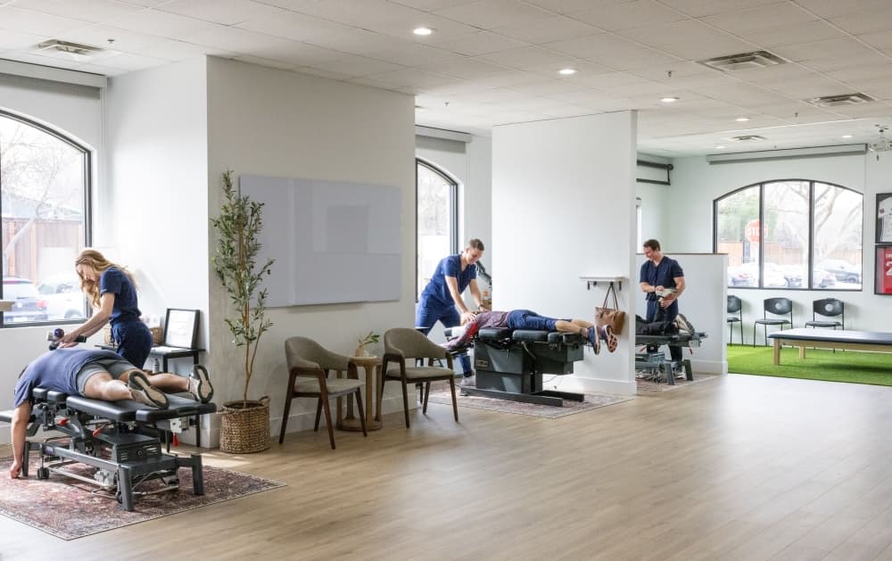 Several chiropractors adjust patients. 