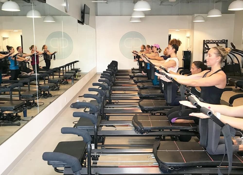 Image shows a Pilates class.