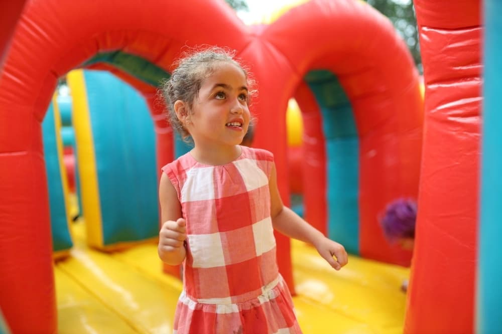Child in an inflatable playpen