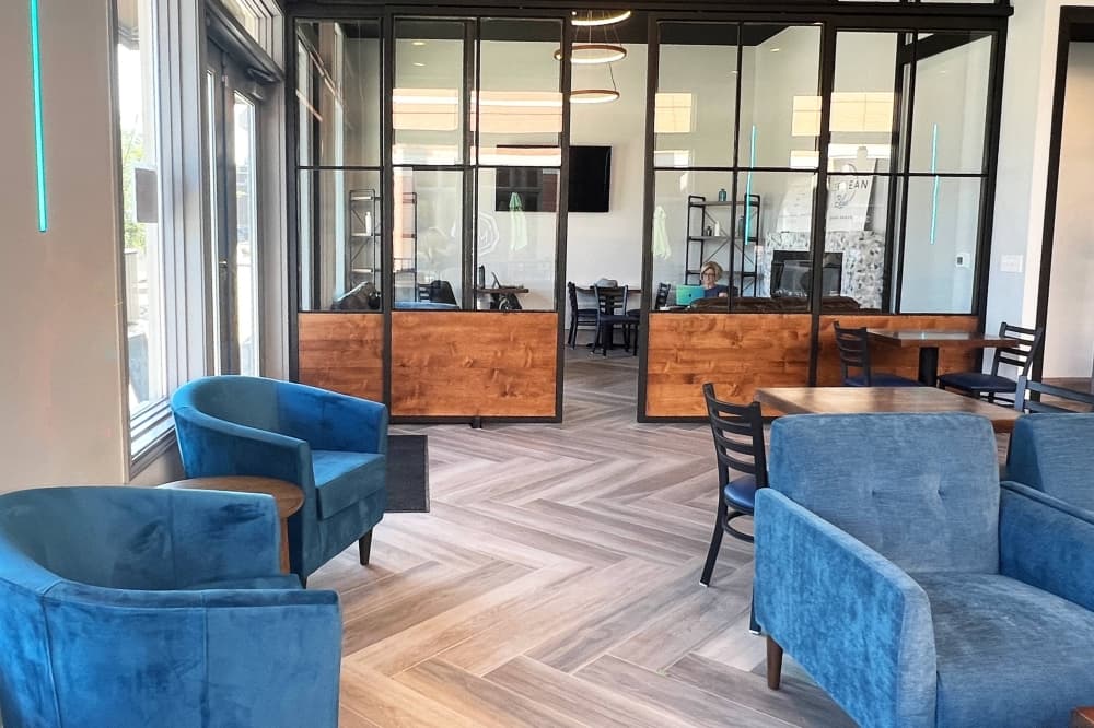 Interior of business featuring blue upholstered chairs.