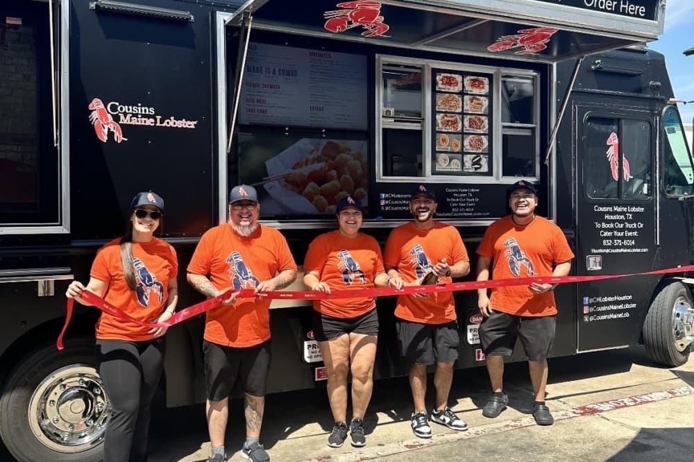 Cousins Maine Lobster staff cut the ribbon on its second Houston area truck at Texas Leaguer Brewing Co. on March 23. (Courtesy Cousins Maine Lobster)
