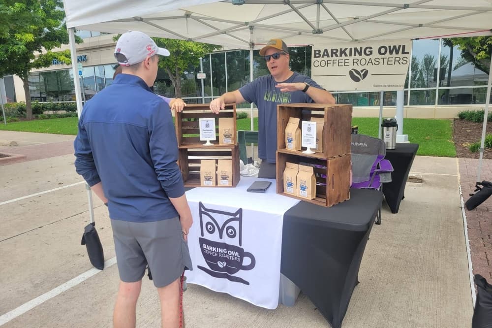 Someone buying coffee at the farmers market