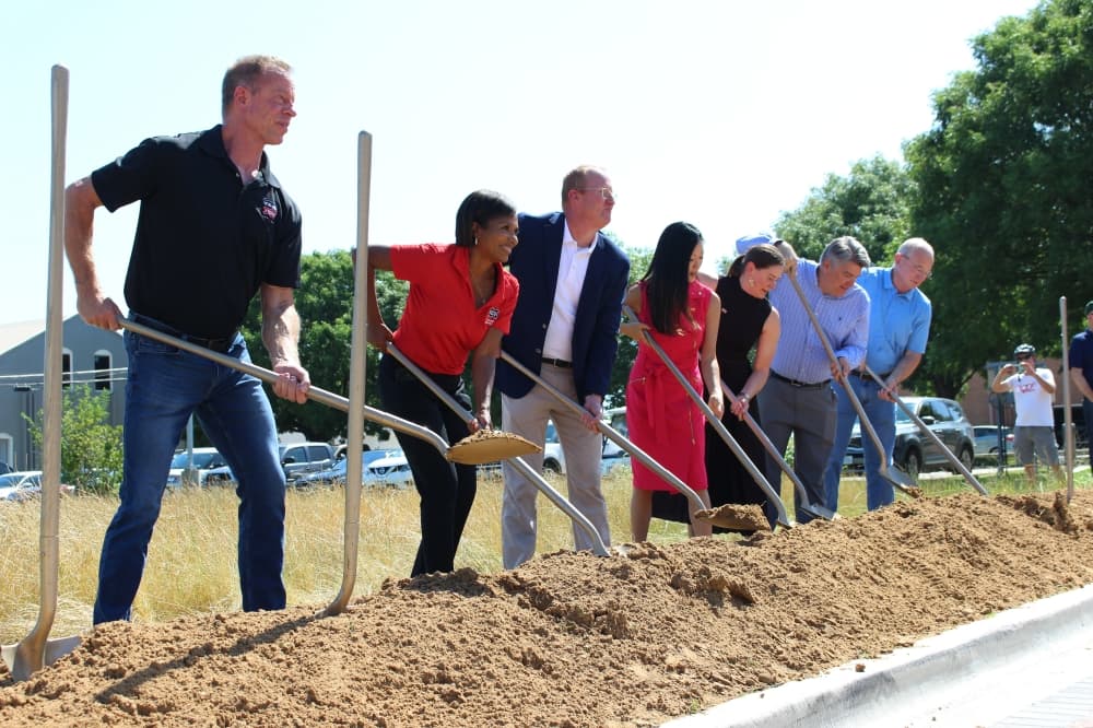 shoveling dirt at groundbreaking frisco 
