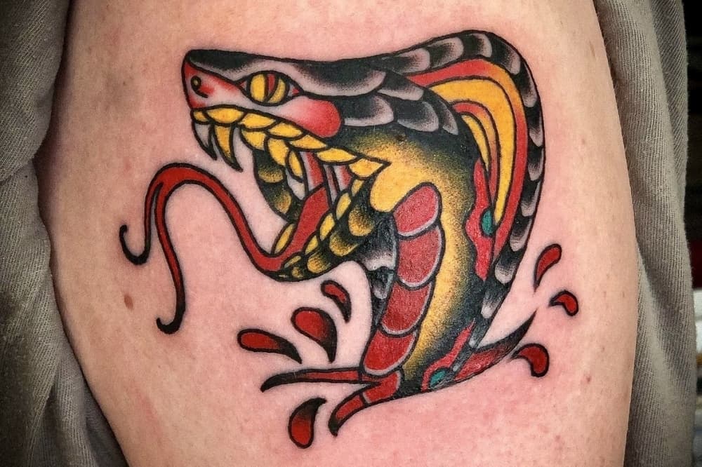 Image shows cobra tattoo.