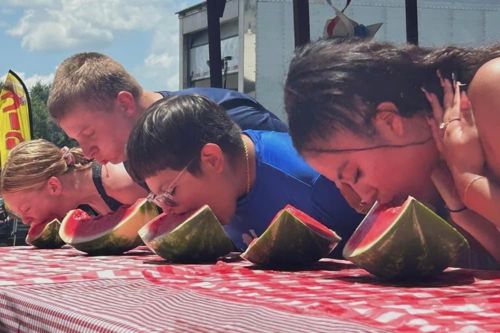 Participants eat watermelon in a contest