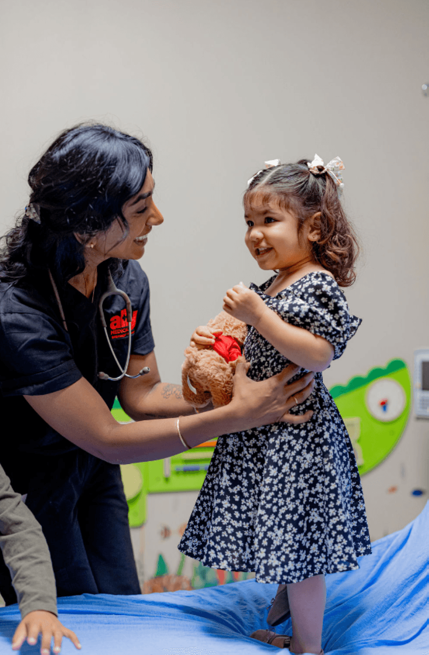 An image of a doctor helping a pediatric patient. 