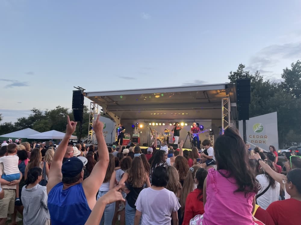 An outdoor picture of a crowd at a previous Cedar Park Fourth of July celebration. 