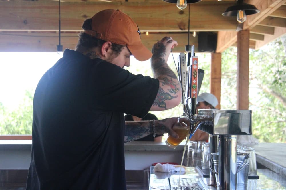 Prescott Shirley pours a beer at Rockabilly Brewing in Hutto. (Grant Crawford/Community Impact)