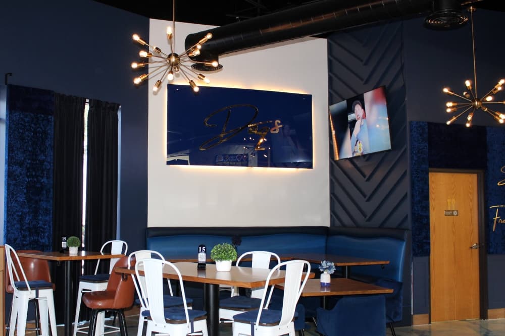 Interior of a restaurant with dark blue walls. 