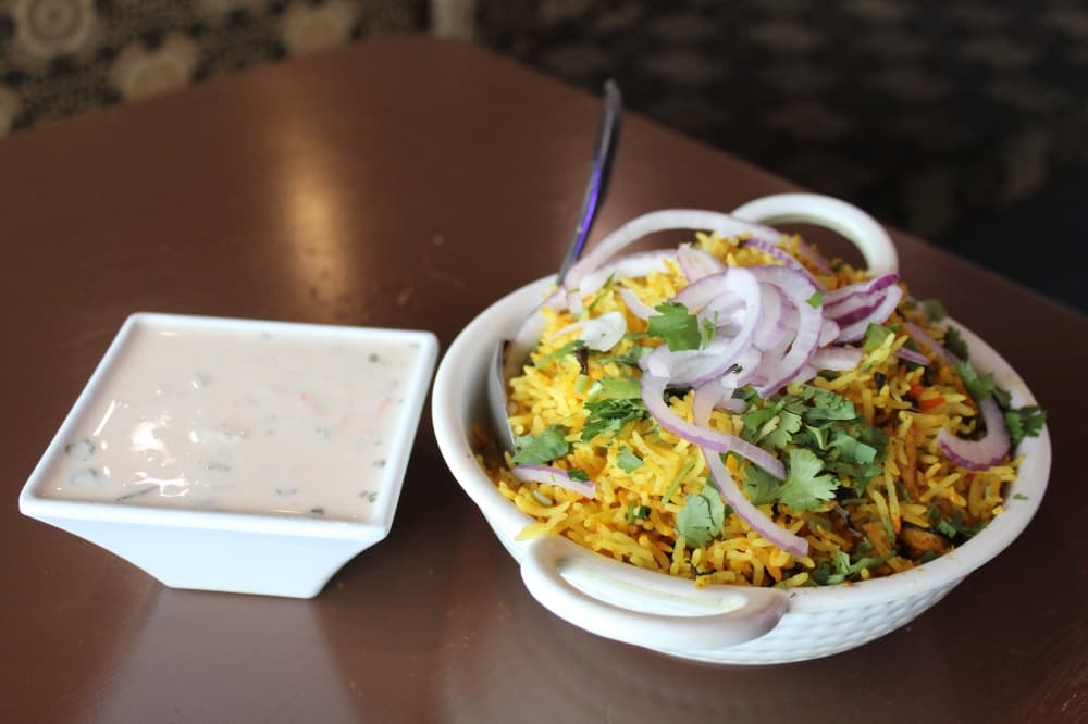 The chicken biryani ($15.49) is served with raita. (Sarah Hernandez/Community Impact)