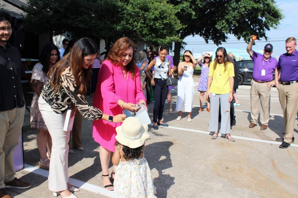Three females of varying ages standing together.