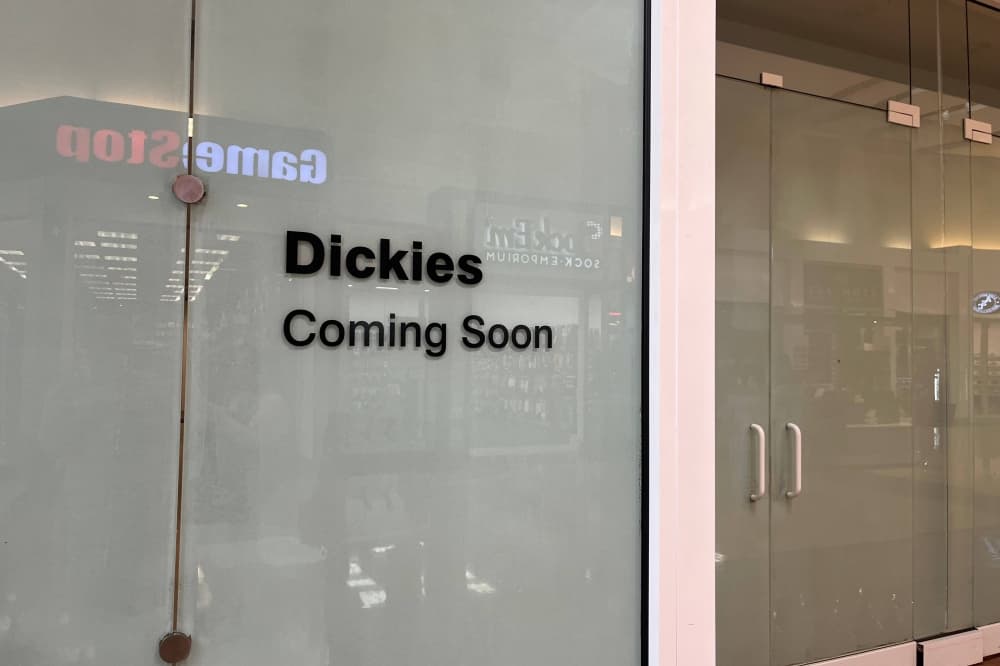 Exterior of glass doors with Dickies Coming Soon signage. 