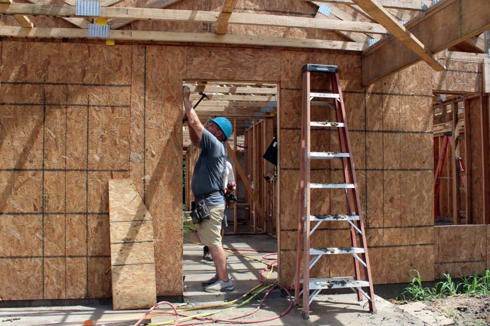 Male working on a house being built. 