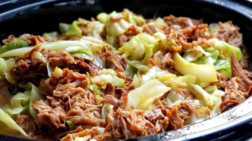 A plate of Hawaiian salted pork with cabbage from Howzit Hawaiian Kitchen in Schertz, Texas is shown.