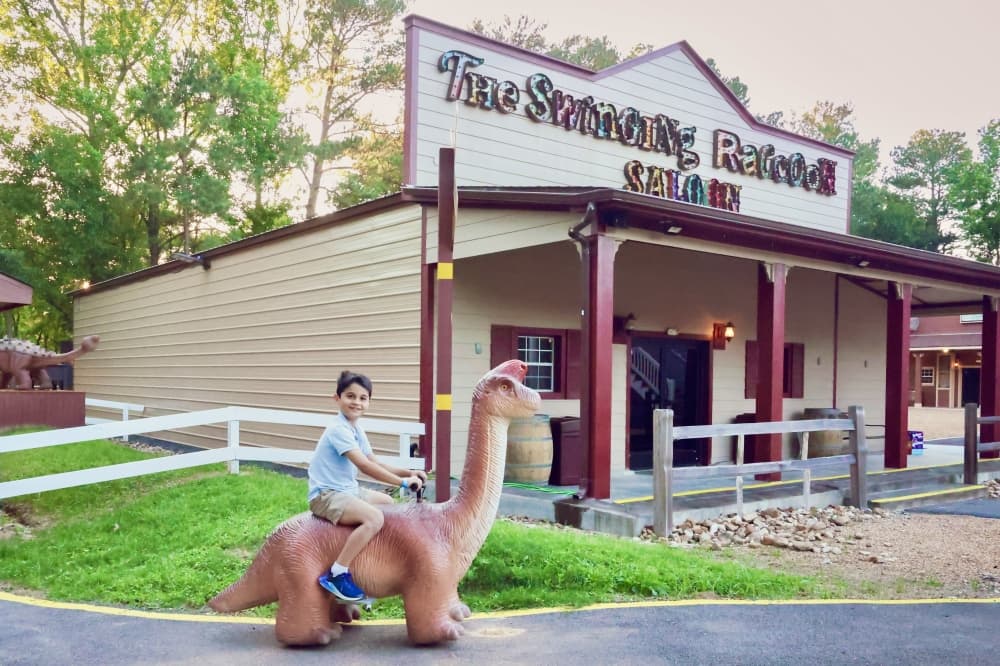 kid on dinosaur scooter