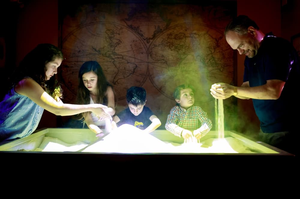 people playing with sand box