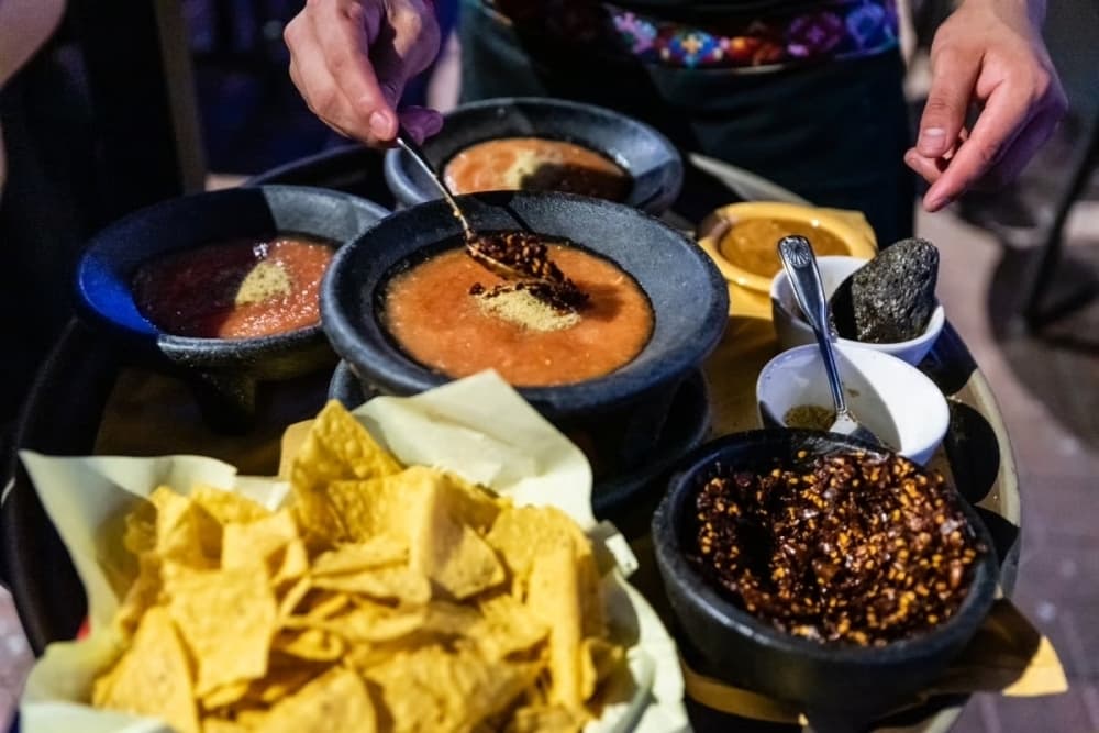 Mexican food is shown on a table.