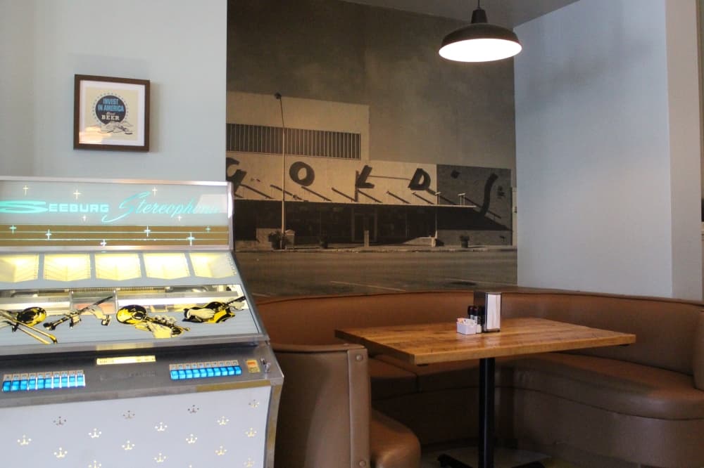 A jukebox sits next to a booth