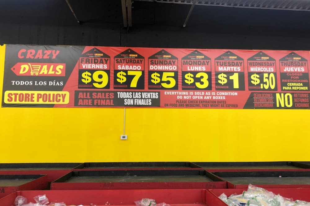 Sign with days of the week and prices listed with each day. 