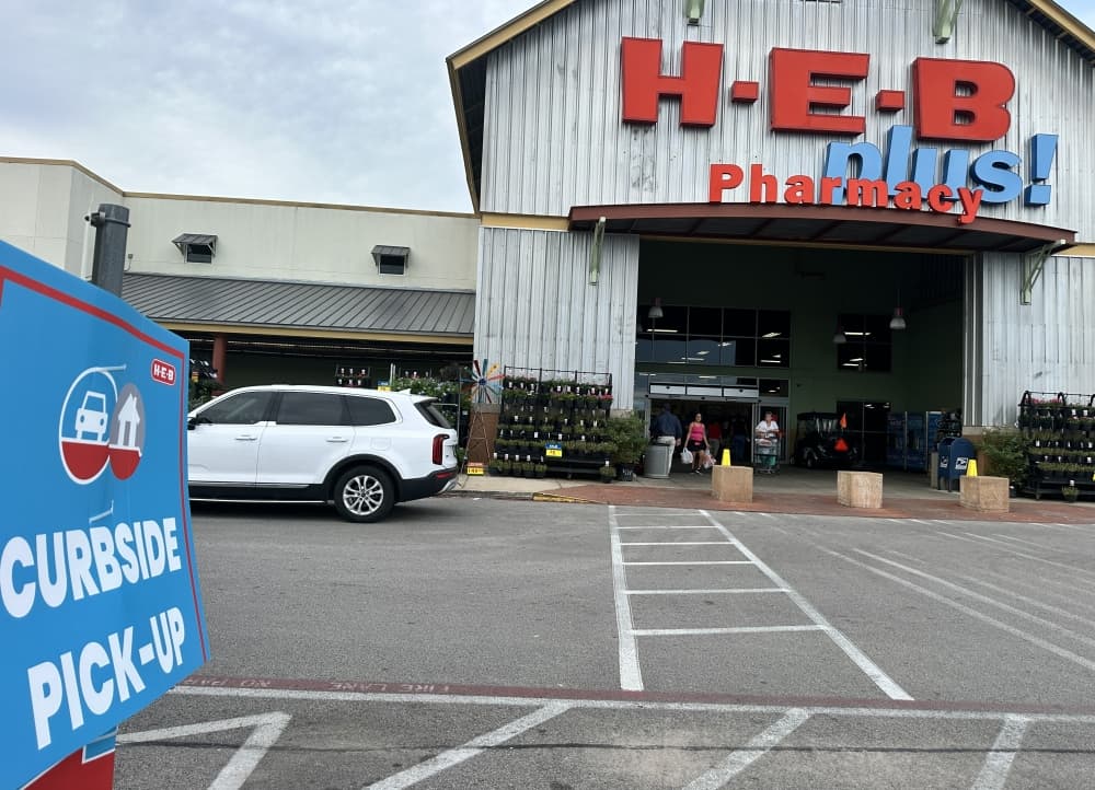 An exterior shot shows the front view of the store where curbside pickup is temporarily located.