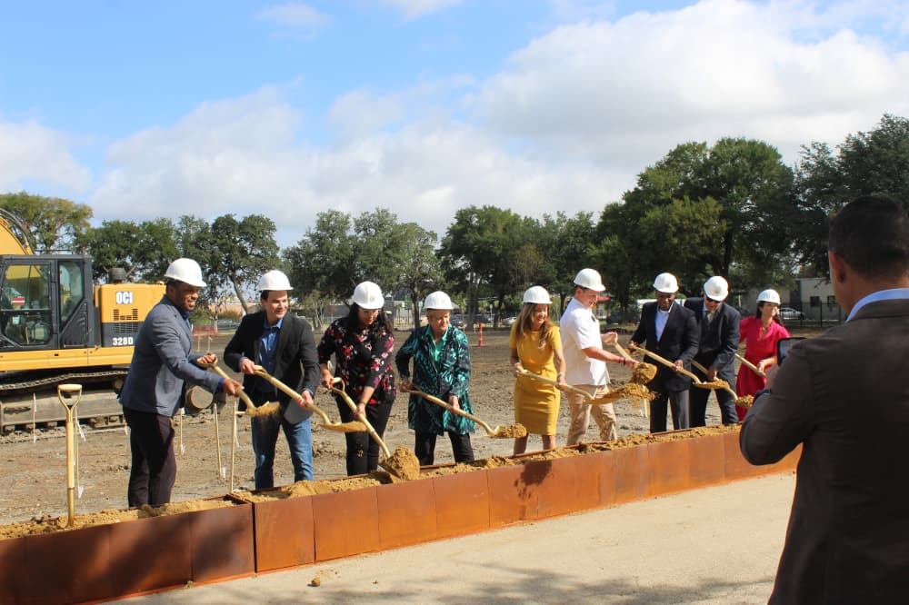 Officials from Kaizen Development Partners and Dallas County lift shovels with dirt during a ceremonial groundbreaking ceremony July 29 in Dallas. 