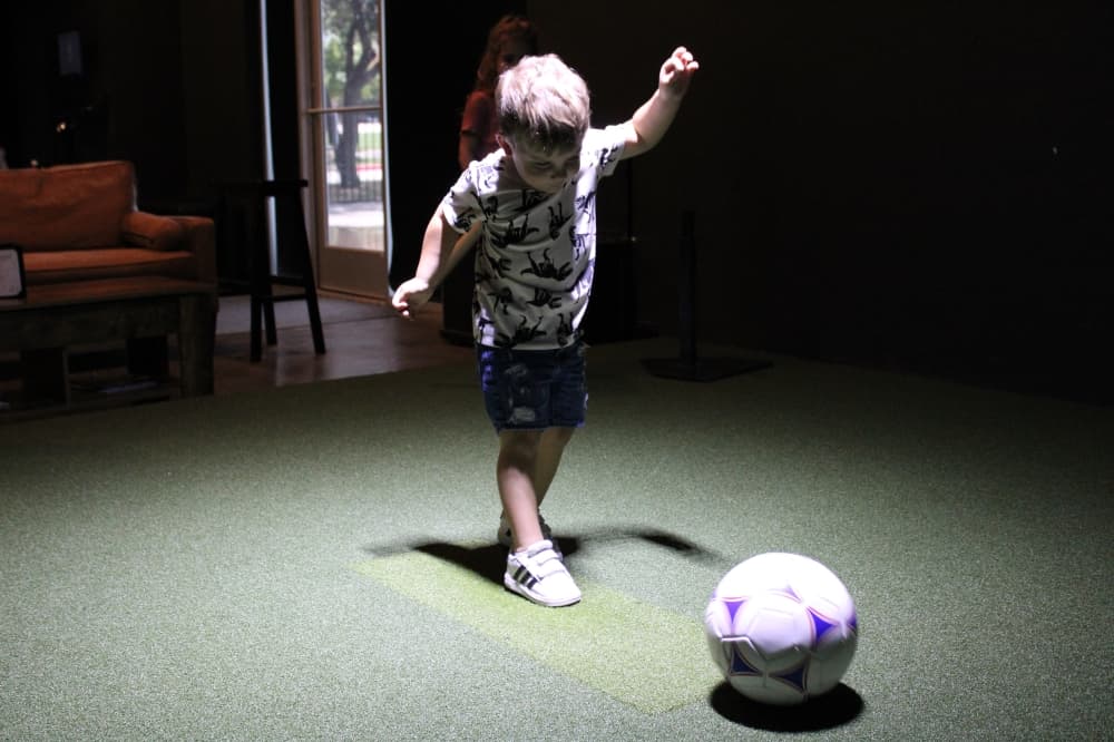 a young boy playing soccor at The Clubhouse