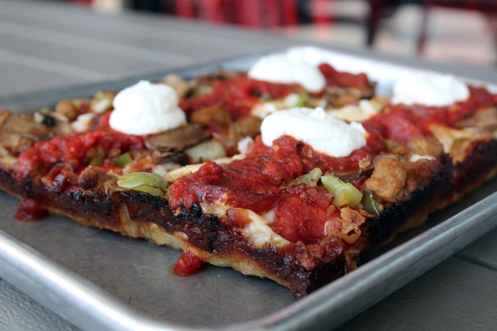 Rectangular pizza with various toppings. 