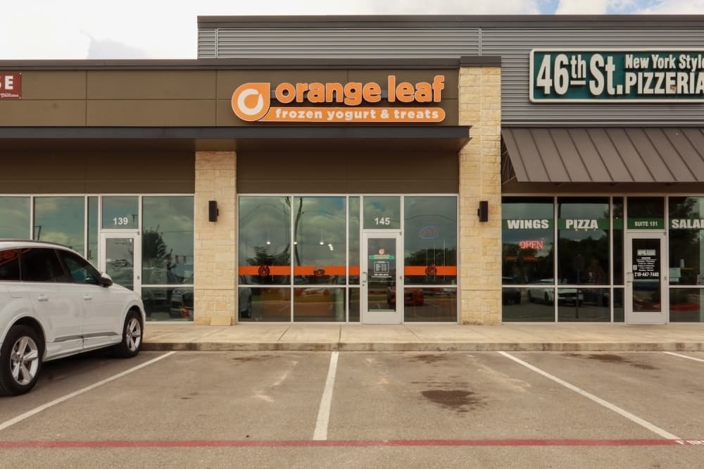 Photo shows exterior of Orange Leaf building.